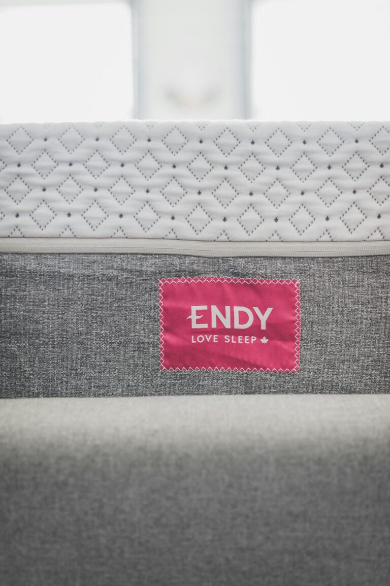 Close-up of modern Endy mattress with a pink tag, highlighting texture.