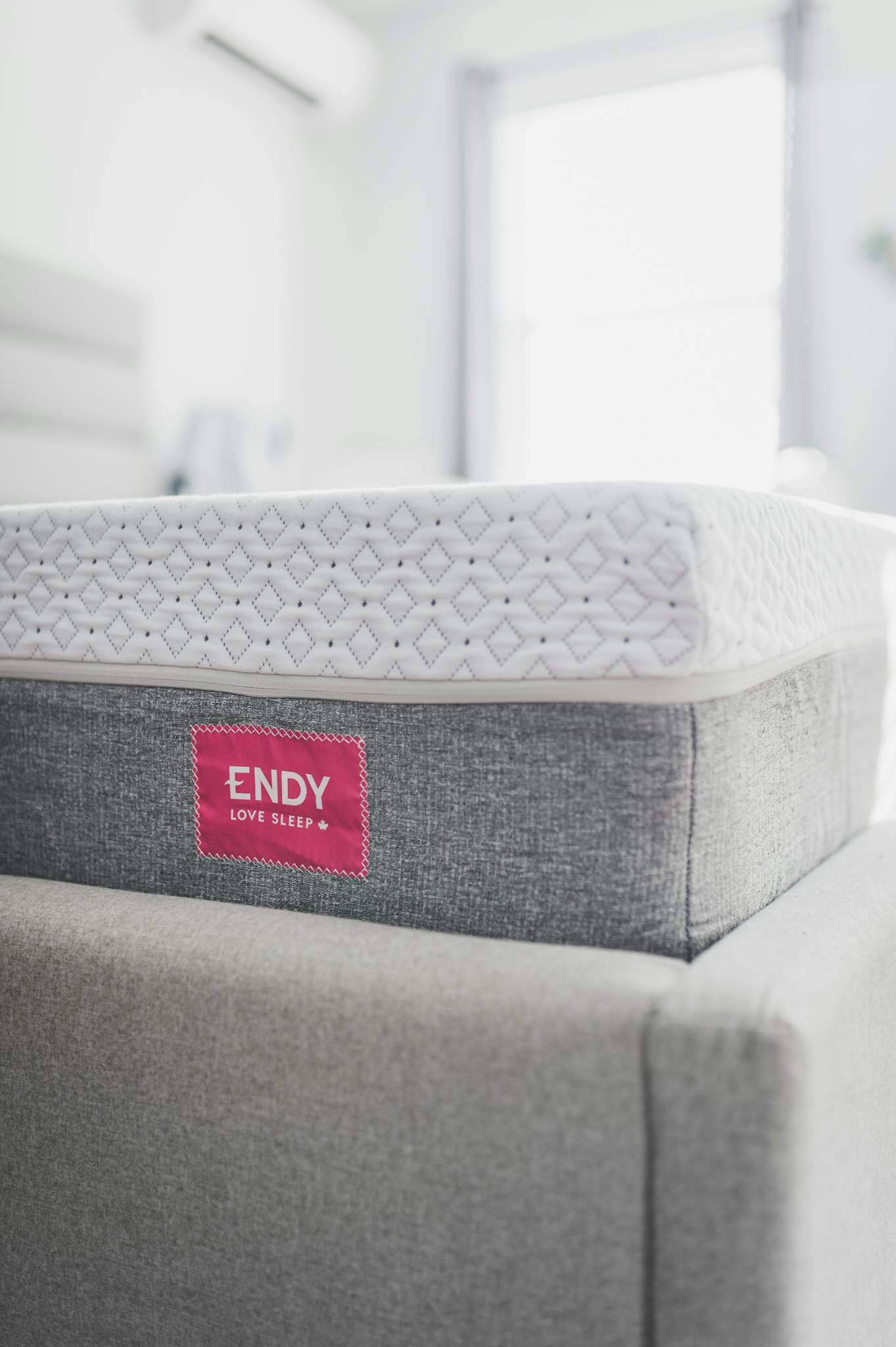 Close-up photo of a comfy Endy mattress on a bed, highlighting texture and design.